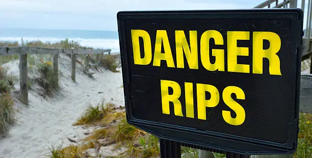 Danger rips of strong currents sign posted on the beach. copy space concept conceptual.