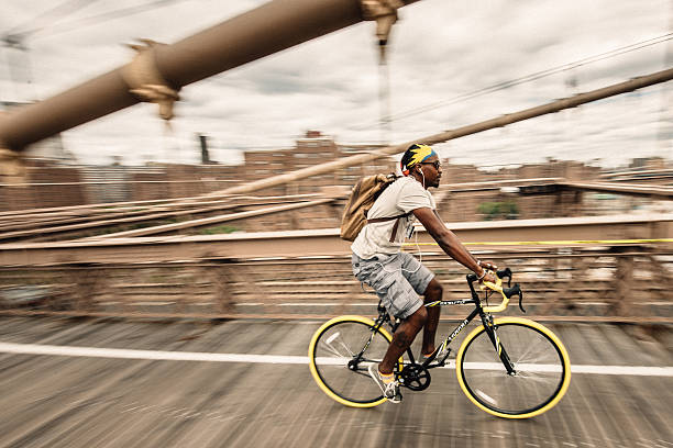 New York City, United States - August 15, 2014: Cyclist crossing The Brooklyn Bridge.