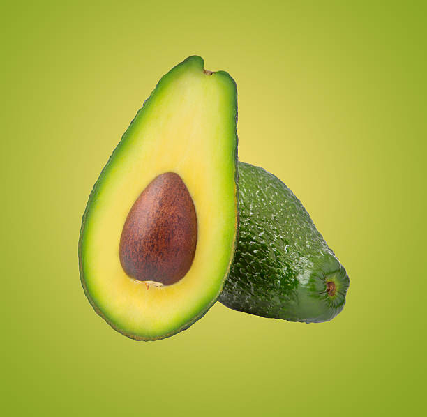 istock Avocado isolated on green background 507898706