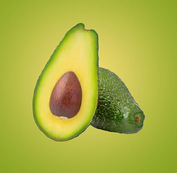 Avocado isolated on green background stock photo