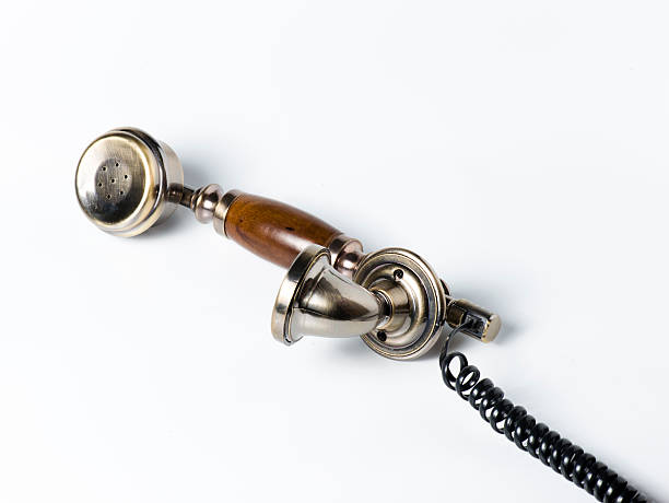istock Old wooden phone receiver on white 507899853
