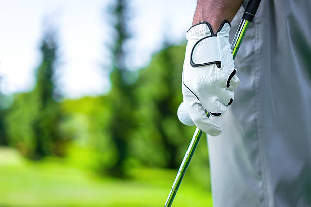Idea Man's hand with a ball and club golf glove stock pictures, royalty-free photos & images