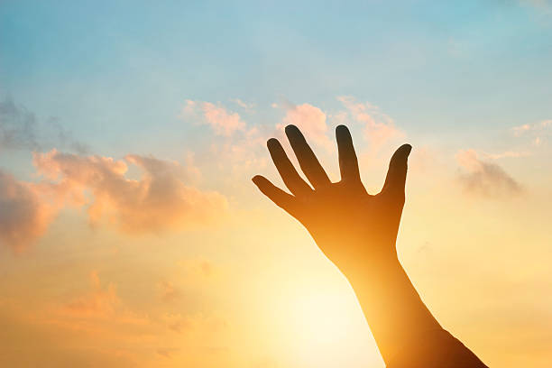 istock hand holding the sky in sunset 507902264