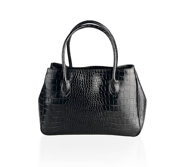 Black leather handbag isolated Beautiful black leather handbag made from crocodile leather isolated on white . leather medical bag stock pictures, royalty-free photos & images
