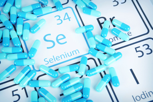 Selenium with capsules or pills on the periodic table (Periodic table made by me)  Stock image representing mineral supplementation.