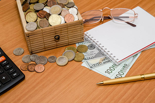 istock open treasure chest with coin. Us dollar and euro, notepad 507903602