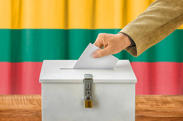 istock Man putting a ballot into a voting box - Lithuania 507903822