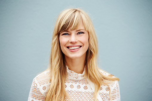 Smiling young blond lady looking at camera