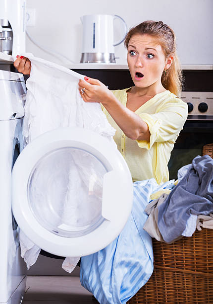 istock Upset girl looking at linen after laundry 507906010
