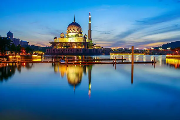 Beautiful reflection of Putra Mosque in the lake during blue hour