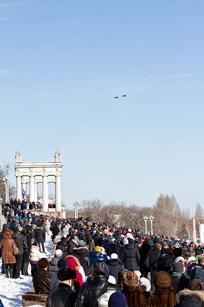 people came to Central promenade on parade of military aviation Volgograd, Russia - January 30, 2016: A large number of people came to the Central promenade to see the parade of military aviation supersonic airplane editorial airplane air vehicle stock pictures, royalty-free photos & images