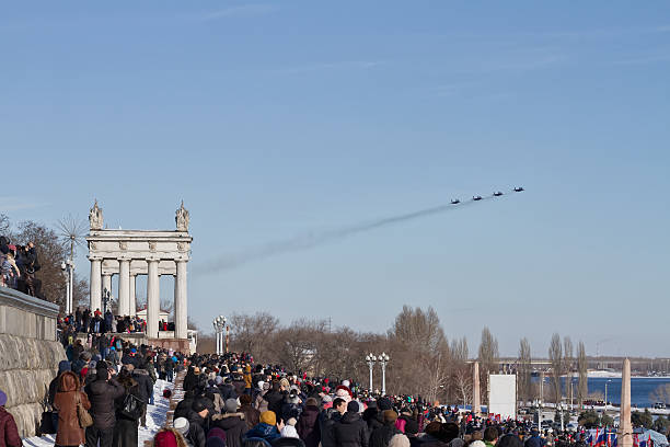 people came to Central promenade on parade of military aviation Volgograd, Russia - January 30, 2016: A large number of people came to the Central promenade to see the parade of military aviation supersonic airplane editorial airplane air vehicle stock pictures, royalty-free photos & images