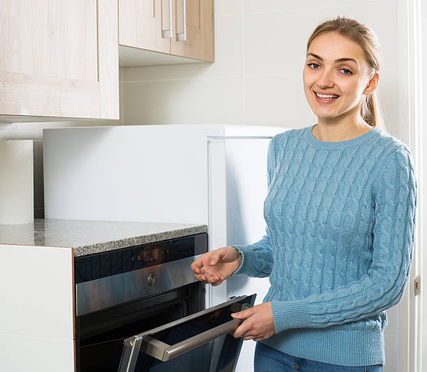 istock Girl near kitchen oven at home 507907372