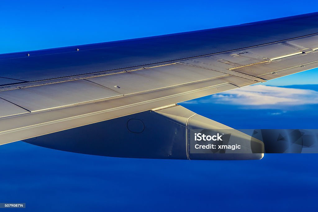 Plane Wing above Sky and Clouds Wing of Plane at Blue Sky Background above Clouds Above Stock Photo