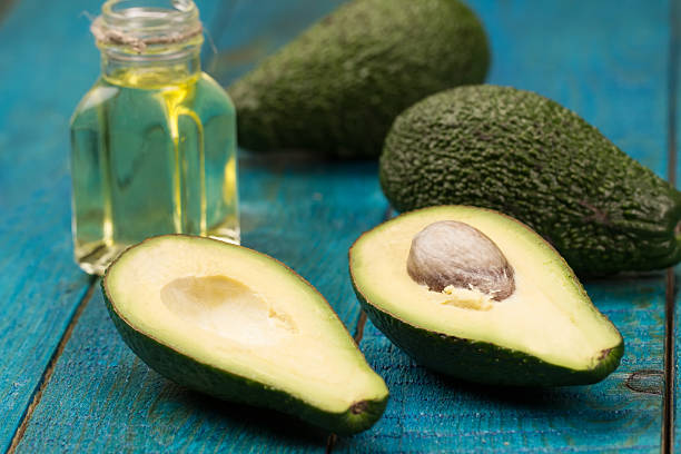 istock fresh avocados on wooden background. 507909720