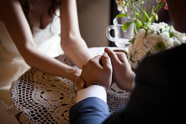 istock Wedding day. Groom and bride hold each other's hands. 507910386