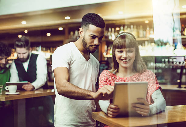 istock Happy couple using digital tablet at coffee shop 507912896