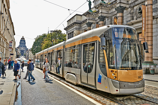 Brussels, Belgium - August 15, 2014: The Royal Museum of Fine Arts with its stone columns and scenic sculptures makes the contrast with the modern tram on August 15 in Brussels.