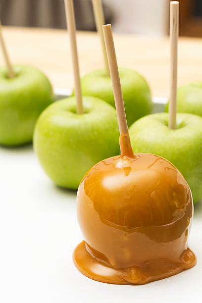 istock Caramel apple in front of others ready to be dipped 507919207
