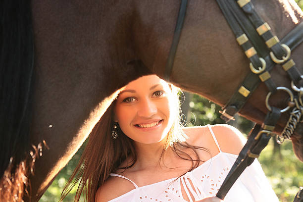 istock girl looking with horse 507920599