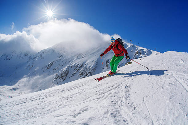 istock Skier skiing downhill in high mountains against sunset 507922239