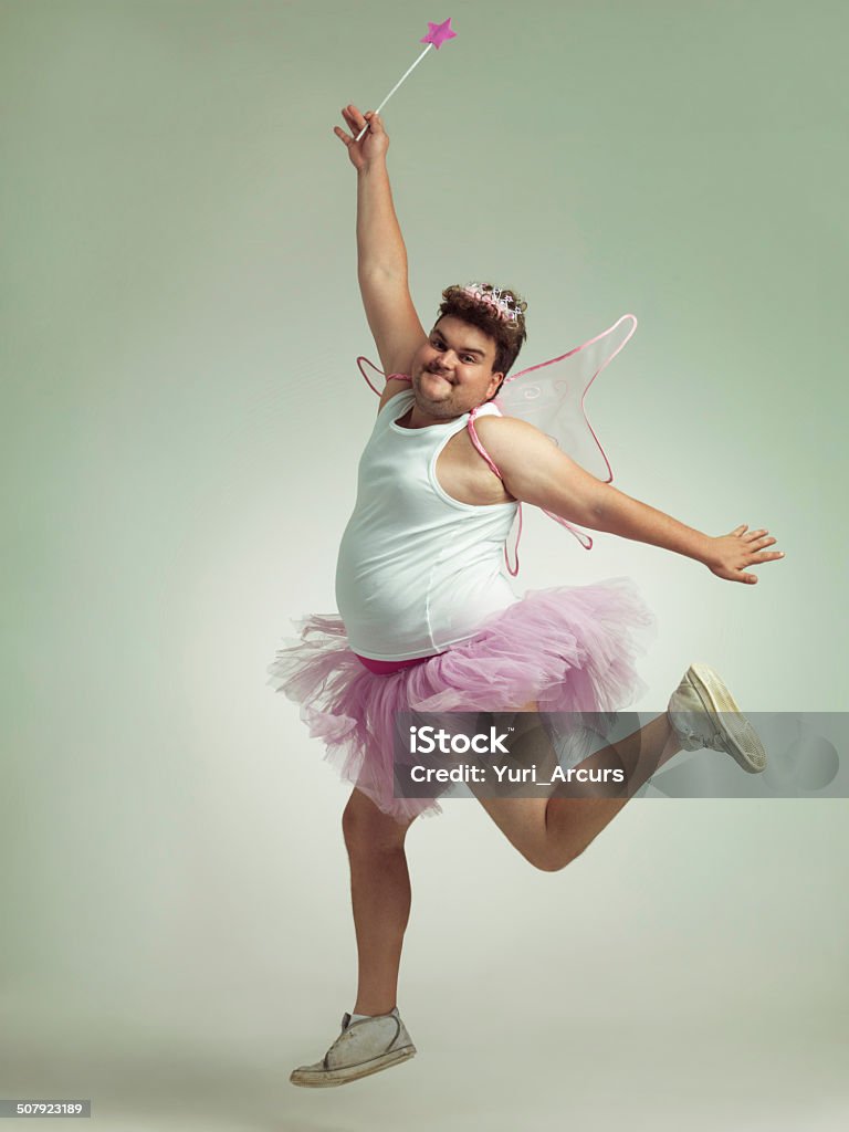 Twinkle toes An overweight man comically dressed-up in a pink fairy costume Fairy Stock Photo
