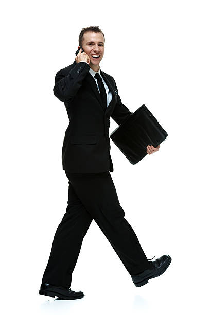 istock Smiling businessman talking on mobile & walking 507923829