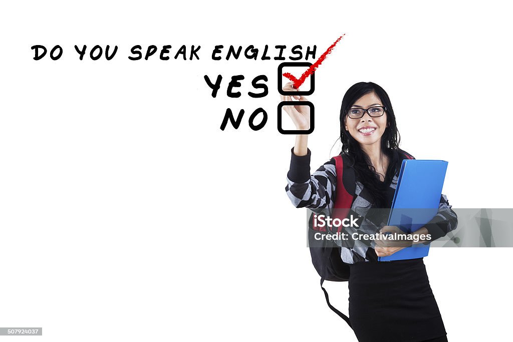 English tutor writes on whiteboard Learning language concept. Female student write Do You Speak English? Adult Stock Photo