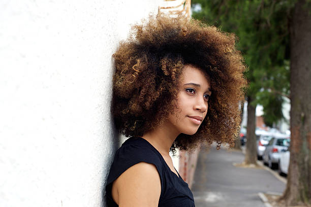 istock Young african woman leaning against wall 507953554