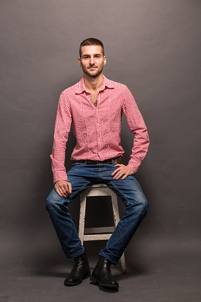 istock Handsome man sitting on a chair in studio 507953912