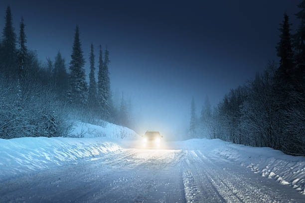 istock Car lights in winter Russian forest 507955259