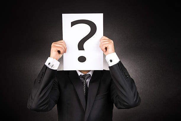 Mysterious Businessman holding question mark