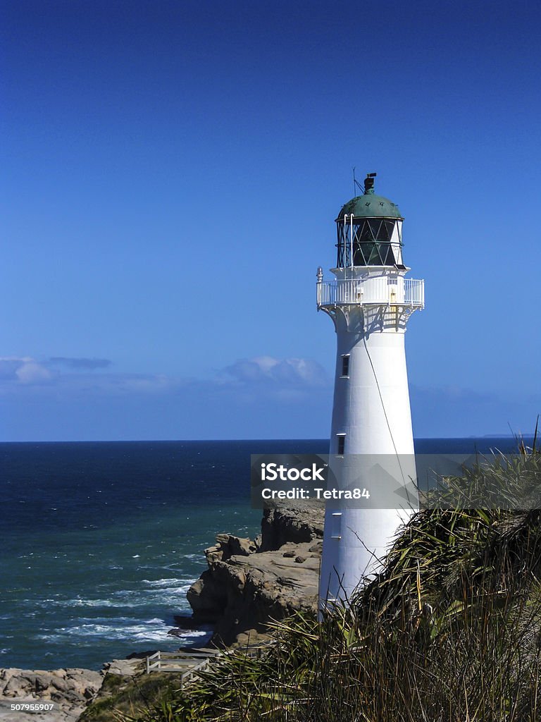 Castlepoint Lighthouse Castlepoint Lighthouse overlooking the Pacific Ocean in New Zealand. At The Edge Of Stock Photo