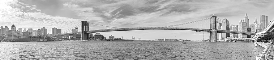 Black and white panoramic picture of the Brooklyn Bridge, New York City, USA.