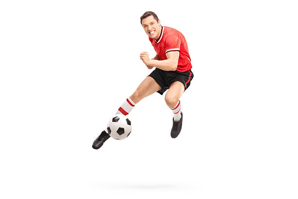 istock Young football player kicking a ball 507957300