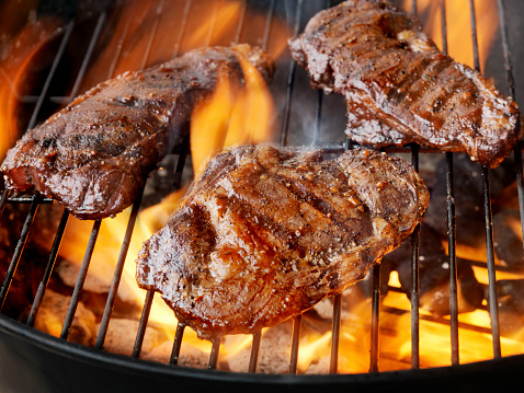 Steaks seasoned with salt and pepper on an outdoor grill -Photographed on Hasselblad H3-22mb Camera