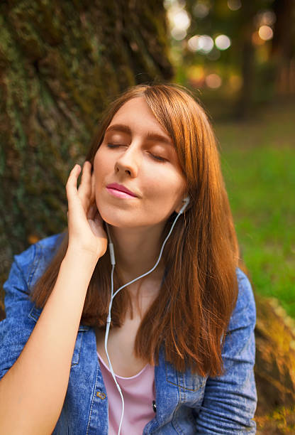 istock Young listenning to music in park. 507959170