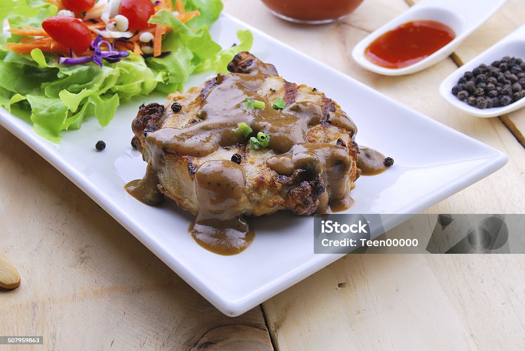 Grilled steaks, pork with pepper gravy and vegetable salad Appetizer Stock Photo