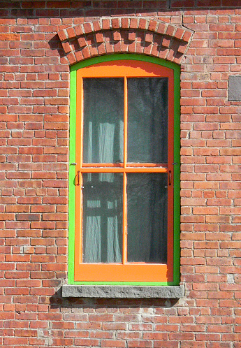 highly colored painted sash of window frame brick exterior view