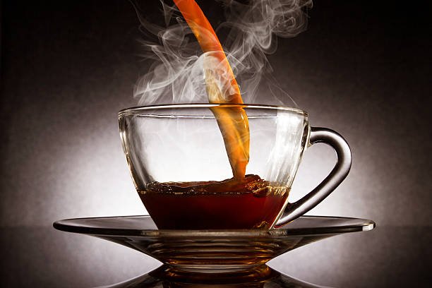 istock Pour coffee into transparent glass cup with dark background. 507982263