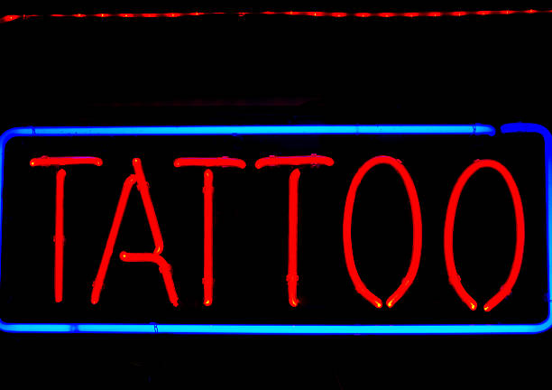 istock Neon Tattoo Sign in Red and Blue with Black Background 507985959