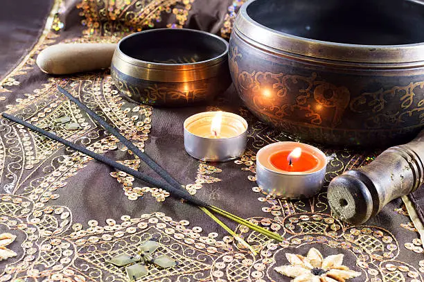 Ethnic still life with Tibetan singing bowls, candles and ethnic sticks