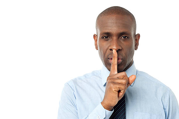 istock Businessman shows silence gesture 507988573