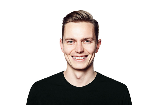 Studio shot of young man smiling to camera. Isolated on white background. Horizontal format, he is looking to the camera, he is wearing a black T-shirt.