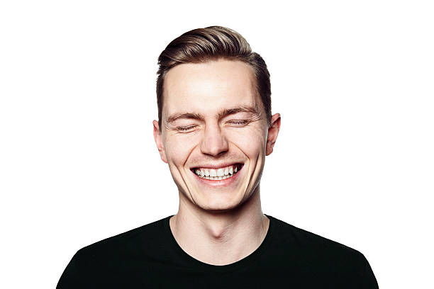portrait of young man smiling to camera - closing eyes men stockfoto's en -beelden