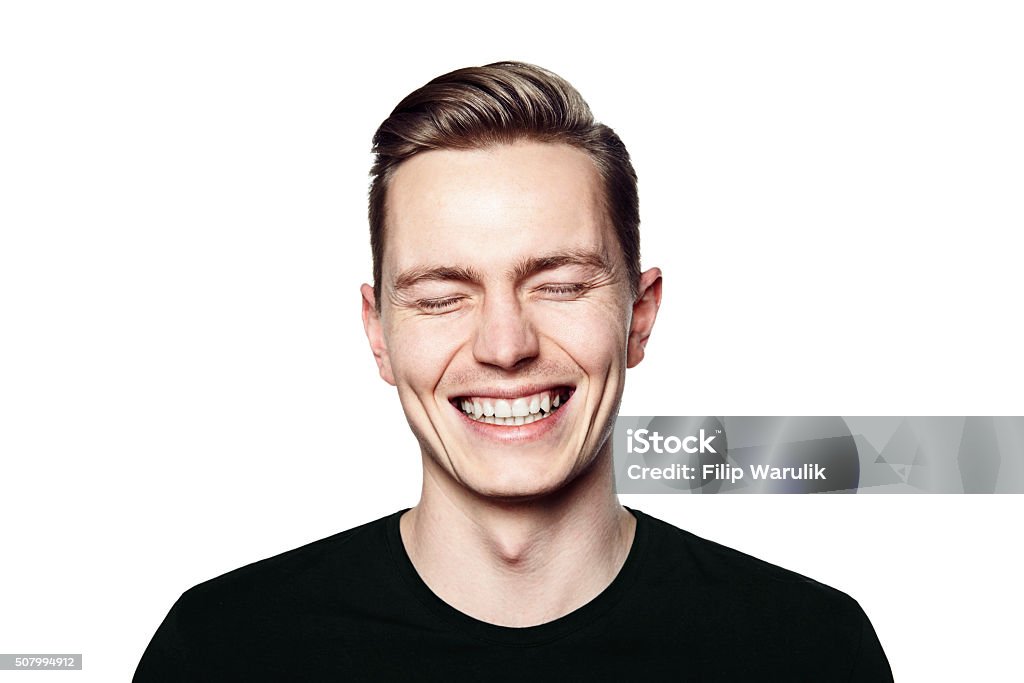 Portrait of young man smiling to camera Studio shot of young man smiling to camera. Isolated on white background. Horizontal format, he is looking to the camera, he is wearing a black T-shirt. Men Stock Photo