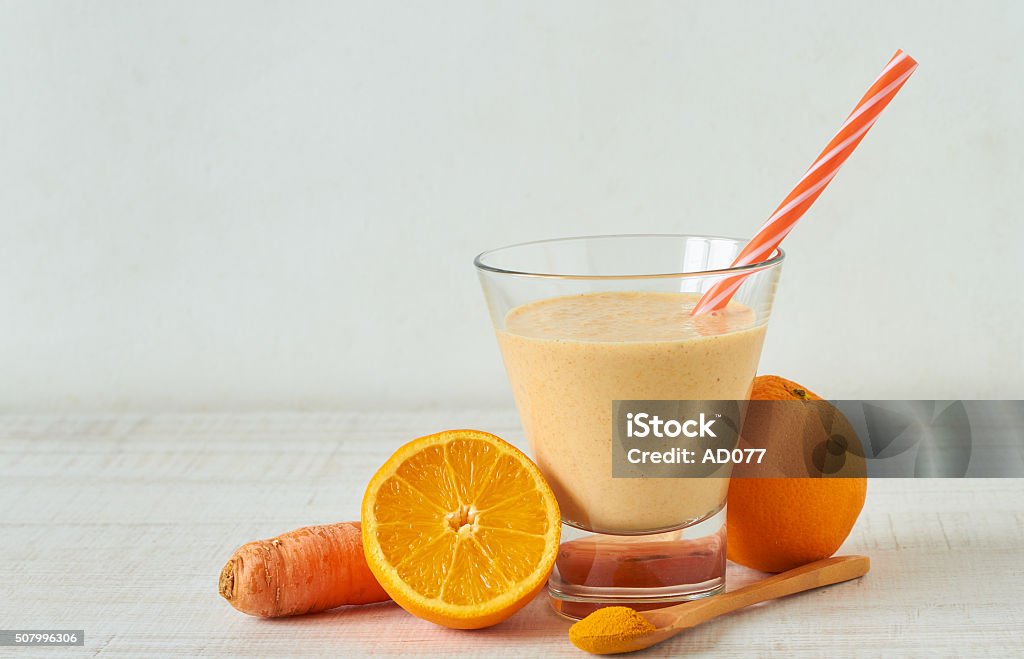 Healthy smoothie Homemade smoothie made from raw almond milk with orange, carrot and turmeric powder Carrot Stock Photo