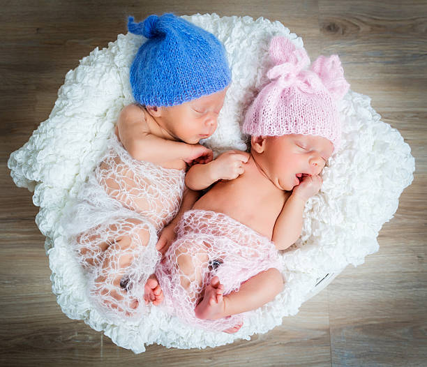 istock newborn twins l sleeping in a basket 507997380
