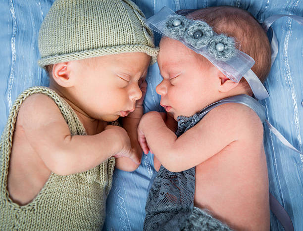 istock newborn twins l sleeping in a basket 507997418