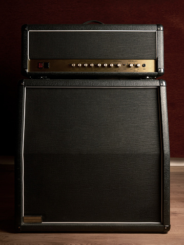 Shot of the front of an old combo guitar amplifier with speaker cabinet